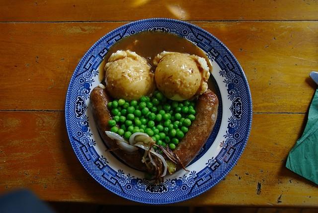 Bangers & Mash on old china plate on wooden table