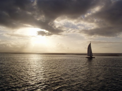 sailboat under clouds