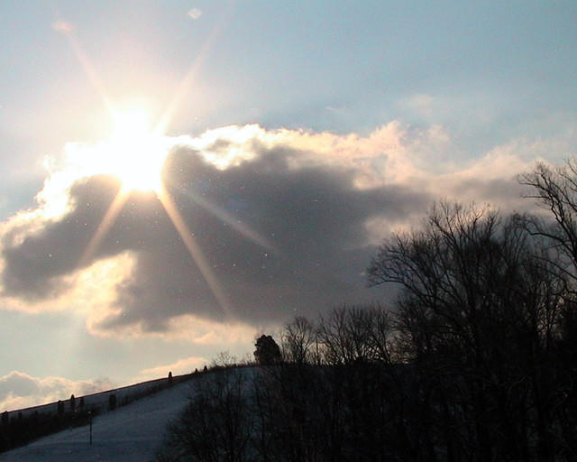 Sunburst Over Snowy Hill